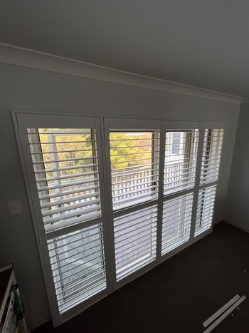 Hinged Infinity Shutters In Front Of Glass Sliding Doors